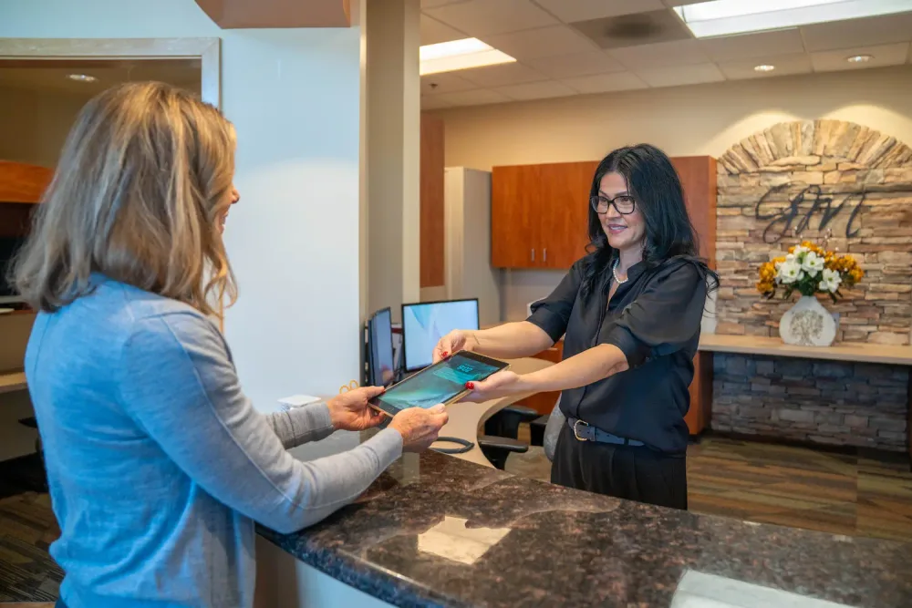 A patient checking in on a tablet at Parkside Dental
