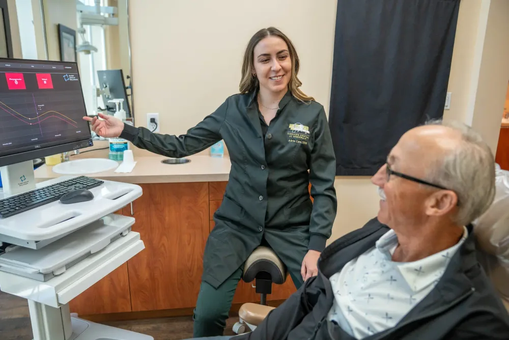 A Parkside Dental hygienist chatting with a relaxed patient in the treatment chair