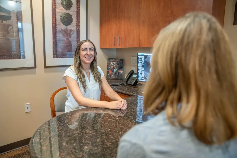 A Parkside Dental team member welcoming a patient at the front desk